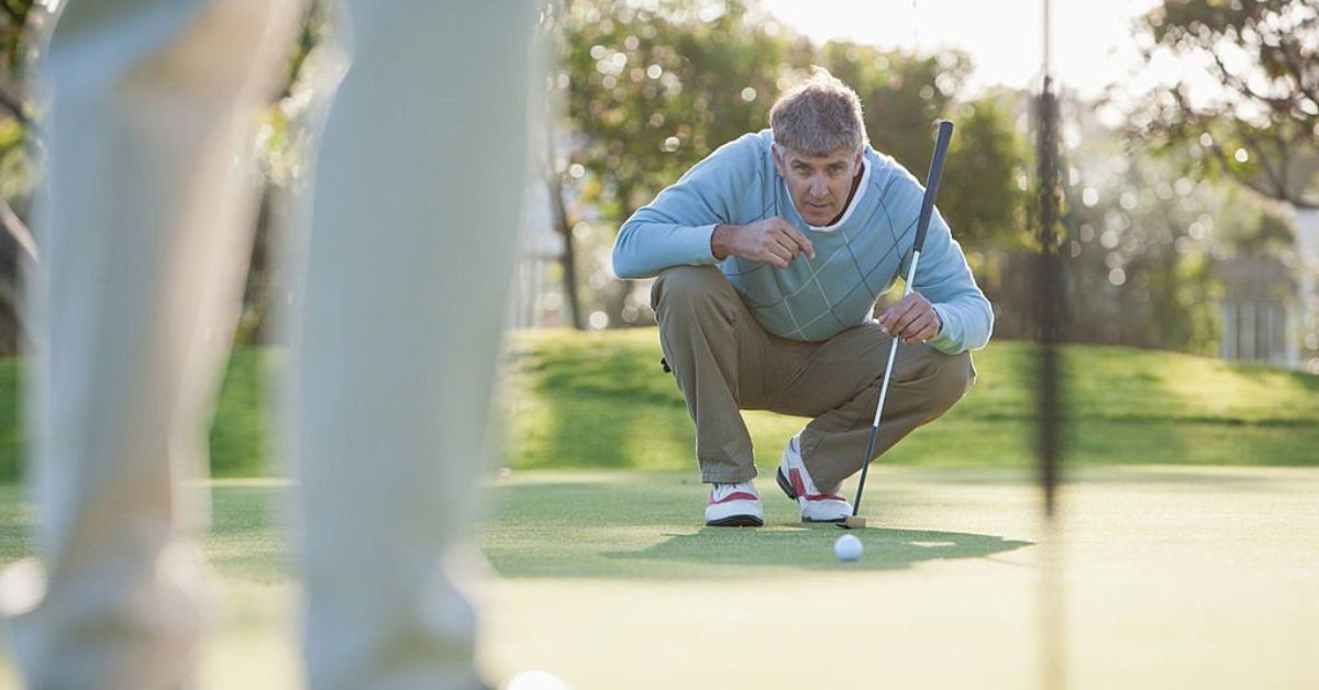 why do golfers straddle the putting line